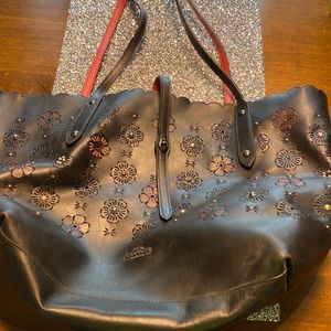Black leather tote with red floral accents